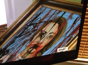 Michonne sees the scary painting, foreshadowing the horrible scene she is about to witness...