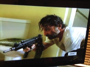 As Rick grabs the man's gun and prepares to go out the bathroom window, he goes back to crack the door of the bathroom open, to set a 