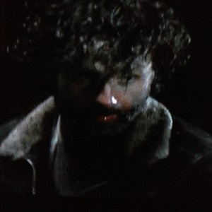 Looking like a crazy killer clown, Rick Grimes turns to his son's would-be rapist, growls,