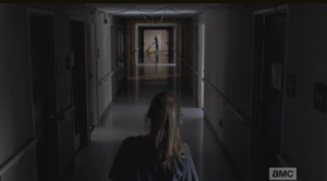 As she peers down the hallway, looking for a point of exit, Beth sees a tall young man, far down the hallway, mopping.