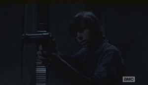 carl raises gun in gabriels office