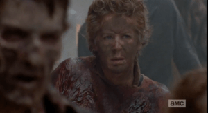 Carol takes in the scene, hidden among the walkers.