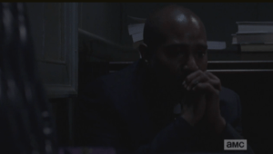 Gabriel clutches his rosary and prays.