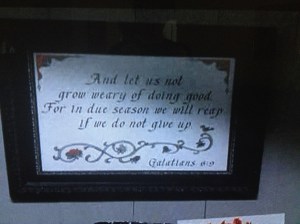 In another room, Glenn finds a framed embroidered quote...
