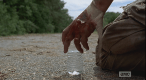 Abraham, relieved that Eugene is alive, chooses life, and reaches for the water.