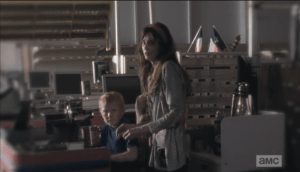 Silently, fearfully, Abraham's wife, Ellen, and their son (who looks like a mini Abraham) and daugher come out from under the desk where they were crouched, hiding...they look at Abraham as if they are terrified of him.
