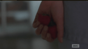 Beth is smuggling strawberries, palming them in her hand as she makes her way down the hallway...