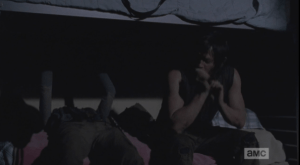 Carol (finally!) goes over to the bunk, lies down next to Daryl.