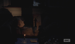 After Carol clears the office and sets up camp inside, she beds down for the night on a couch in the office.