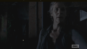 Carol stands watch, rekilling walkers as they approach the two, as Daryl jimmies the lock of the back gate, leading into the rear entrance of the law firm.