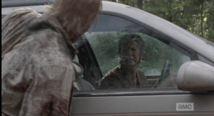 Carol's much needed cry is soon rudely interrupted by Snoopy Walker, who snarls and flails at the car window, trying to get to her. She screams at Snoopy Walker to leave her alone, before peeling off down the road.