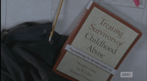 Carol sees that Daryl slipped the book from the temporary housing into his bag, most certainly carrying the wounds of his own abusive childhood deep inside. Carol looks at Daryl, who picks up the book and shoves it at her before stalking off through the doorway. Carol hesitates a moment before following him.