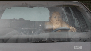 ...and the final image, before the opening title sequence, shows Carol staring in openmouthed horror as the prison goes up in flames.
