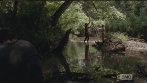 Caught one! Glenn asks Rosita if she knows how to clean a fish, and she laughingly replies that she does...