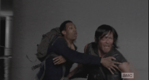 Daryl, anguished, tries to run to her, but Noah holds him back, telling him that they can help her, that they have the power, and the equipment, to help her, and if Daryl runs out there, he will have to fight them, kill them, and then she won't be helped, and does he want that?