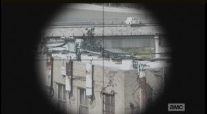 A white van, with the telltale white cross painted on the rear windows...it looks abandoned, hanging halfway off an overpass.