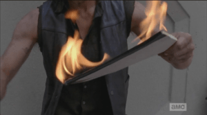 Ever handy, ever resourceful, Daryl sets a legal pad on fire and tosses it out into the street...