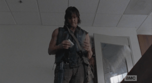 As Noah struggles and pleads, pinned under the bookcase, and the walker paws through the crack in the door, Daryl finds a carton of cigarettes, pulls out a pack, taps the pack, uncaring, against the heel of his hand, opens the pack, and shakes out a cigarette. Carol watches this...