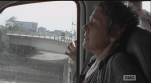 Carol quickly buckles herself in, braces herself, frightened.