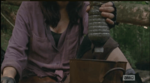 With the water bottle, what looks like some rocks, some torn cloth, and a lot of patience, Rosita fashions a water filtration system that Eugene showed her...it takes awhile, but the water collected is clear, ready to be boiled.