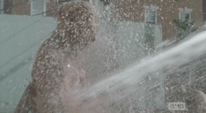 Suddenly, a strong sprauy of water takes down the walker horde...