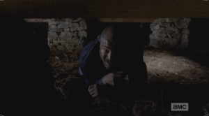 Once he pries up enough boards, Gabriel squeezes himself through the opening in the floor and belly-crawls under the church, until he is outside.