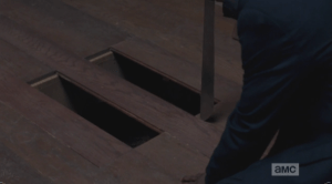 ...and gets back to work prying up the floorboards with the machete, making an escape hole to crawl away through, under the chuch. WTF?