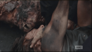 ...and it's a close call for Daryl, a couple of times, as Officer Baldy tries to shove him into the snapping Naplam Walkers...