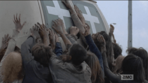 As the walkers swarm the van and paw at it...