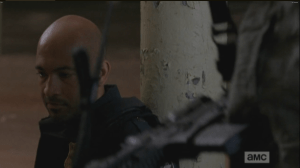 As Sasha pulls up a concrete block and sits beside Lamson, she practically cuts his zip ties and hands him her assault rifle.