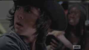 Inside the church, Carl and Michonne, who is holding Baby Judith, are shocked to hear Gabriel screaming for help outside the church.