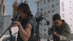 As Daryl and Sasha see the cop car approaching, Daryl signals Tyrese to radio as much to Rick.