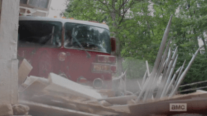 ...a perfectly timed fire truck smashes through, barring the doors and saving the day!