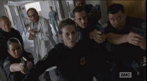 As the officers draw their weapons, Shepherd tells them to hold their fire...