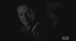 Aaron allows himself a smile, looking on as Michonne flips through the pictures. Houses, buidlings, the wall...but something key is missing from all the pictures...