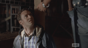 Aaron looks up at Rick, horrified.
