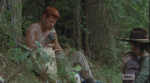 Abraham sniffs the bottle, then takes a drink. 