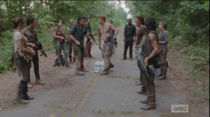 Abraham steps quickly forward and slaps the bottle right out of Eugene's hand, sending the water flying.  Eugene looks like he is about to cry, and Rick tells him, gently, that they can't take the risk.