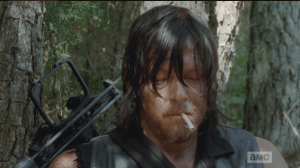 Pulling out a stash of battered cigarettes and a lighter, Daryl lights one up.