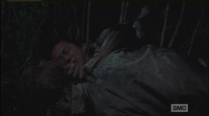 Glenn smashes Look Out Behind You's undead brains in against a rock.