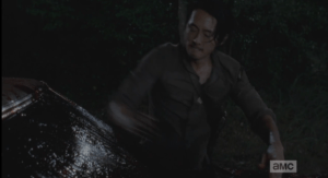 Glenn quickly tries to wipe the windshield clean before jumping back in the car...