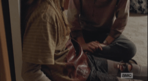 We see this image of a little girl sitting, wearing a blood-soaked shirt, with another girl sitting beside her... we cannot see their faces, at first, but then we recognize the girls....