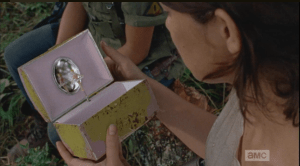 Maggie then reaches into her bag, and pulls out the music box.