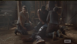 Maggie, kneeling beside Aaron's unconscious form, turns and gently tries to chime in the voice of reason. 