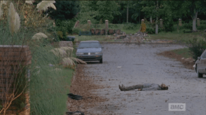 Rick and Glenn turn to look at the wall, considering Michonne's idea, but it's looking pretty obvious to me that some living foe rammed the stone wall down...aren't those tire tracks, still on the ground, from where the vehicle plowed through?