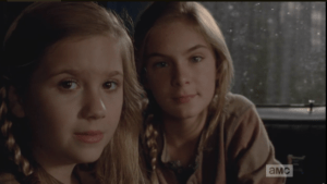 Mika and Lizzie are riding in the back with Tyreese. Their wounds, and blood, are gone now too.