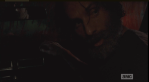 Rick turns and watches Aaron freaking out.