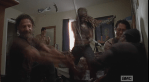 ...and the scene shifts quickly to Rick, Glenn, and Michonne, holding Tyreese while Michonne swiftly amputates poor Tyreese's bitten arm.