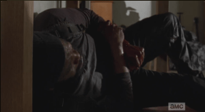 Tyreese is in agony now, struggling to get himself under a desk for some degree of cover. He looks up at Second Act Walker, dead, body slumped over a desk chair. The walker's blood is dripping...