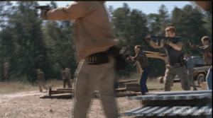 Abraham rushes forward to help Tobin and the others fire upon the oncoming walkers.